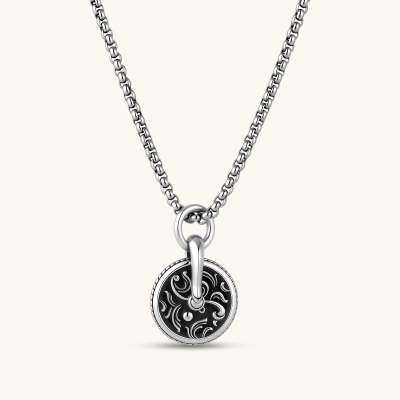Round 925 sterling silver medallion charm with black enamel fill, scrollwork engraving, rope border, and bold bail ring.