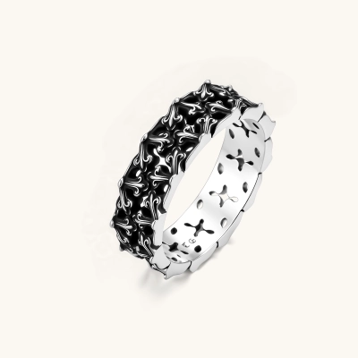 Sterling silver band ring with oxidized black fleur-de-lis cutwork pattern, 6.5mm wide, on white background.