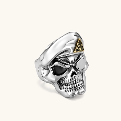 925 sterling silver skull ring wearing a military beret with a gold triangular cannabis leaf badge, blackened eye sockets, 23.9g.