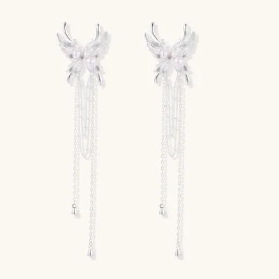 Pair of feather-textured wing earrings with white beads, zirconia accents and long chain tassels on a white background.