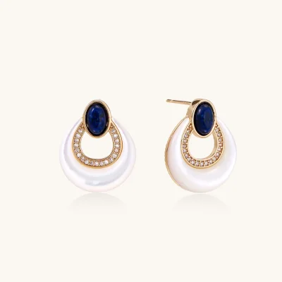 Gold plated stud earrings with an oval lapis lazuli top, CZ-lined teardrop loop and white MOP crescent on a cream background.