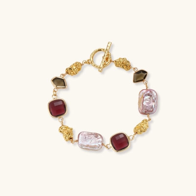 Gold plated toggle bracelet with baroque freshwater pearls, burgundy square stones, smoky brown stones and gold nugget links.