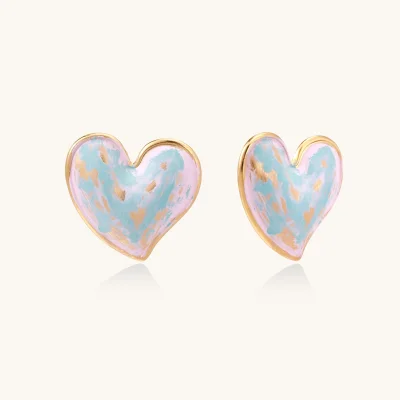 Heart-shaped stud earrings with swirled turquoise and pink enamel in gold-plated frames on cream background