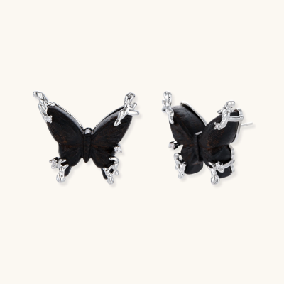 Black ebony wood butterfly stud earrings with silver metallic accents and zirconia details on white background.