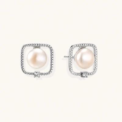 Rhodium-plated silver stud earrings with cushion frame, centered freshwater pearl, and tiny crystal accent