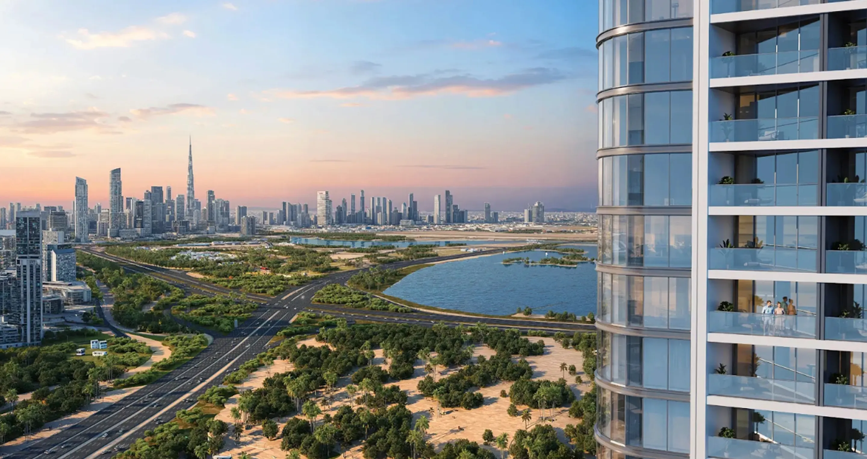 View of a modern city skyline at sunset with a curved glass building and balconies overlooking a highway, greenery, and a body of water.
