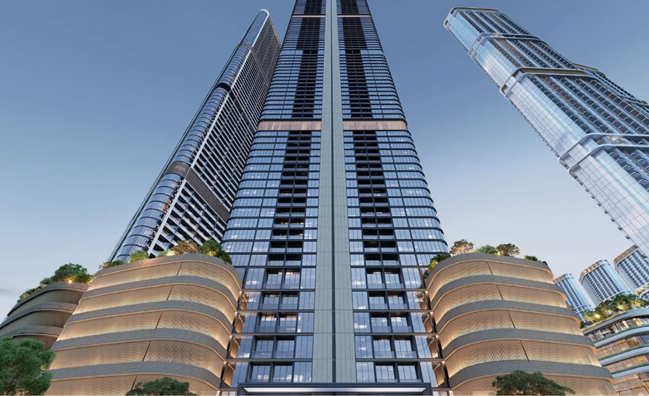 Low-angle view of three modern skyscrapers with glass facades against a clear blue sky.