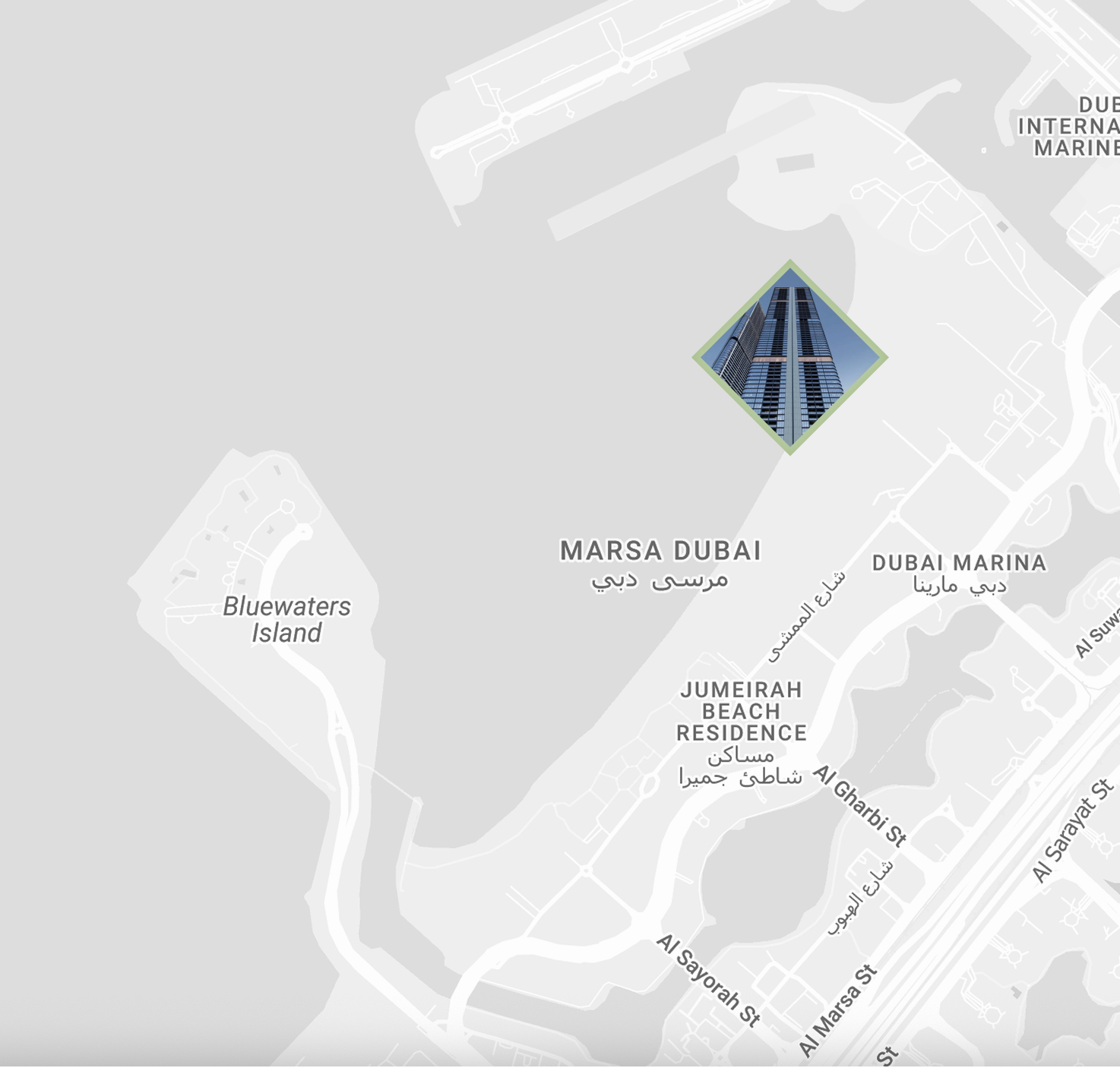 Map section of Dubai showing Bluewaters Island, Marsa Dubai, Dubai Marina, and Jumeirah Beach Residence with an inset photo of a tall modern skyscraper.
