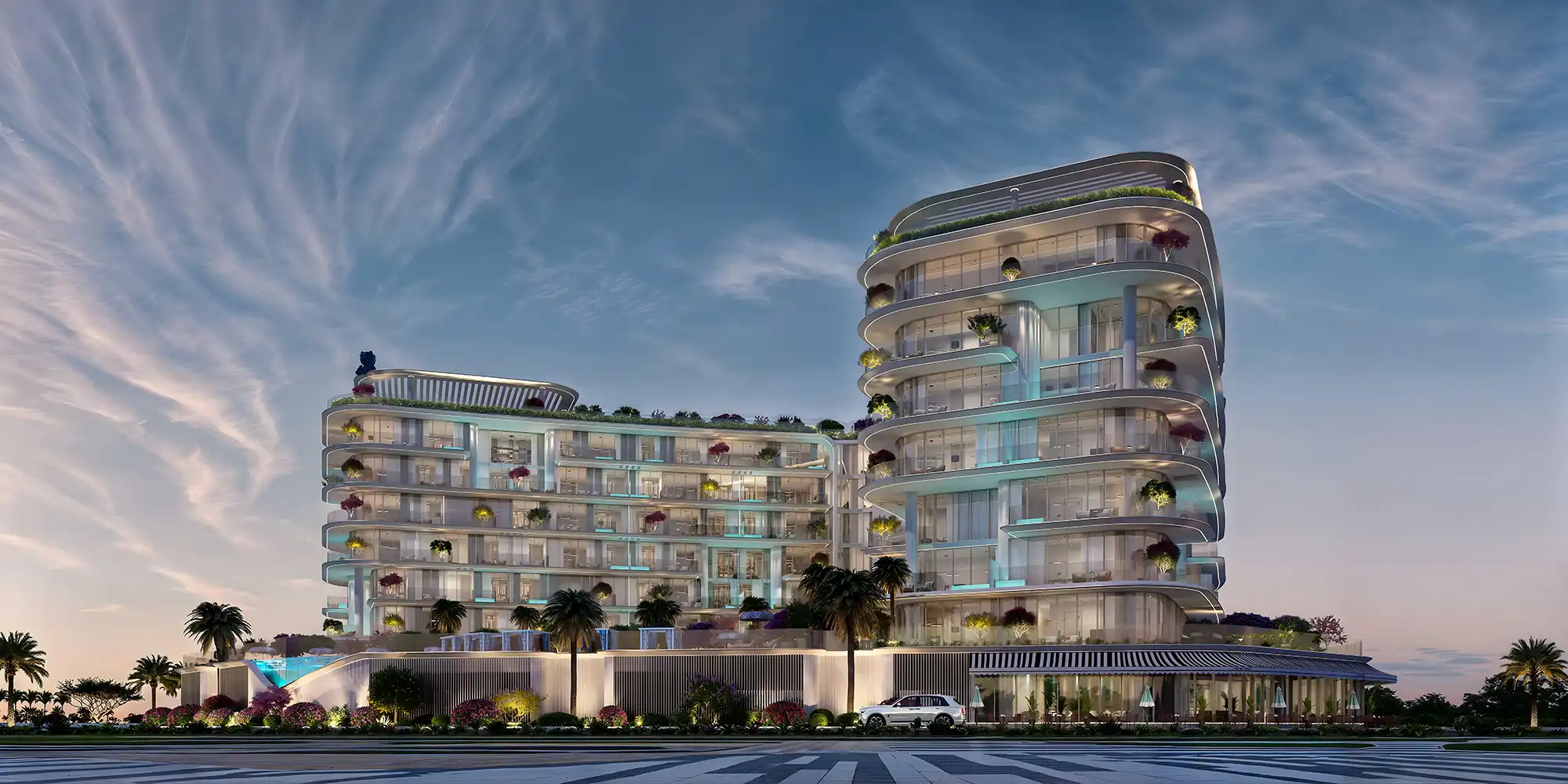 Modern multi-story building with curved balconies, rooftop greenery, and palm trees at dusk.