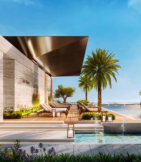 Modern outdoor poolside lounge area with wooden deck, sun loungers, palm trees, and a clear blue sky.