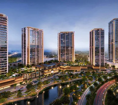 Modern high-rise residential towers surrounded by landscaped greenery and water features during dusk.