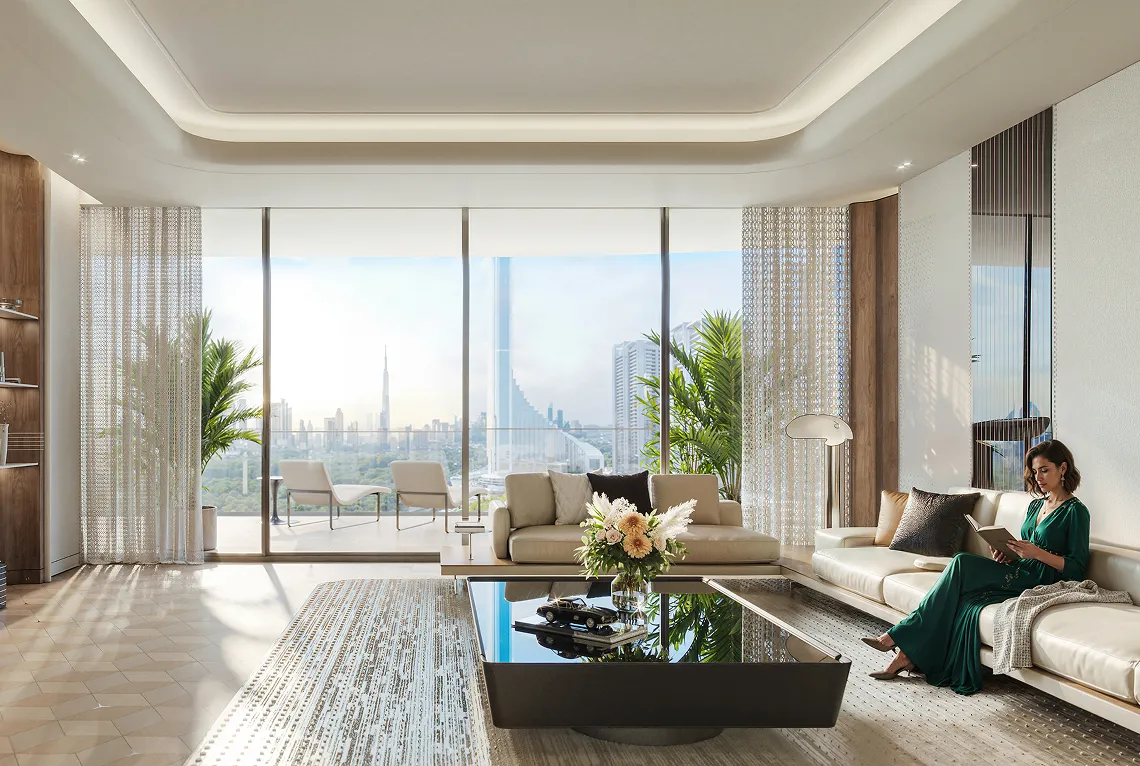 Modern living room with large floor-to-ceiling windows overlooking a city skyline, featuring beige sofas, a black glass coffee table with flowers, and a woman in a green dress reading a book.