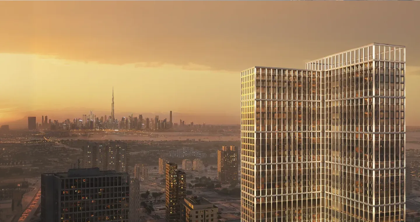Sunset view of a modern glass skyscraper with cityscape and Burj Khalifa in the background.