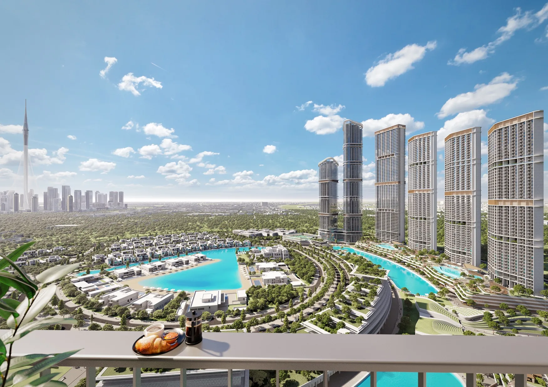 Balcony view overlooking a residential complex with curved buildings, blue water canals, greenery, and a city skyline under a clear blue sky.