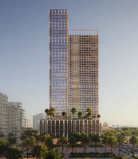Modern twin high-rise buildings with glass facades surrounded by palm trees at dawn or dusk.
