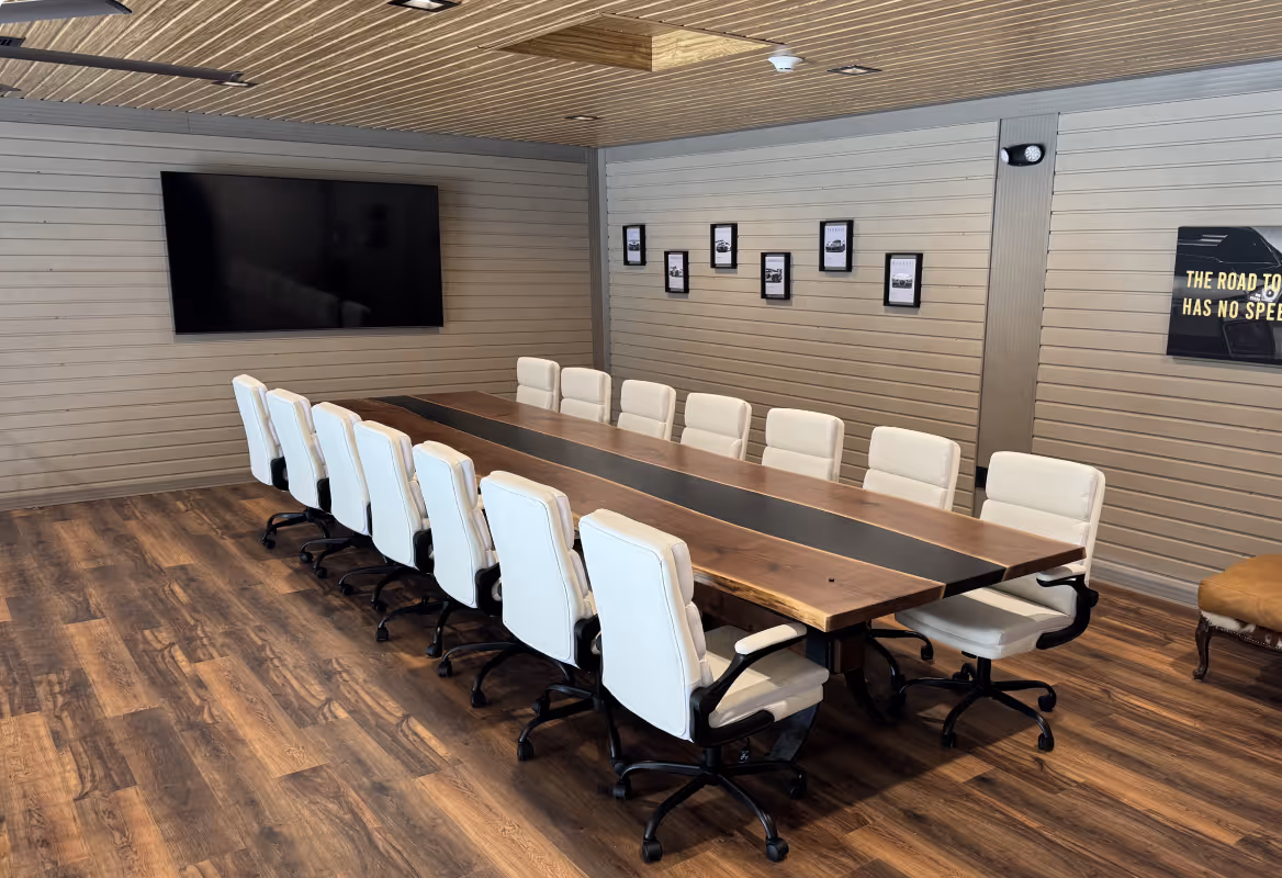 Conference room with table, chairs, and tv