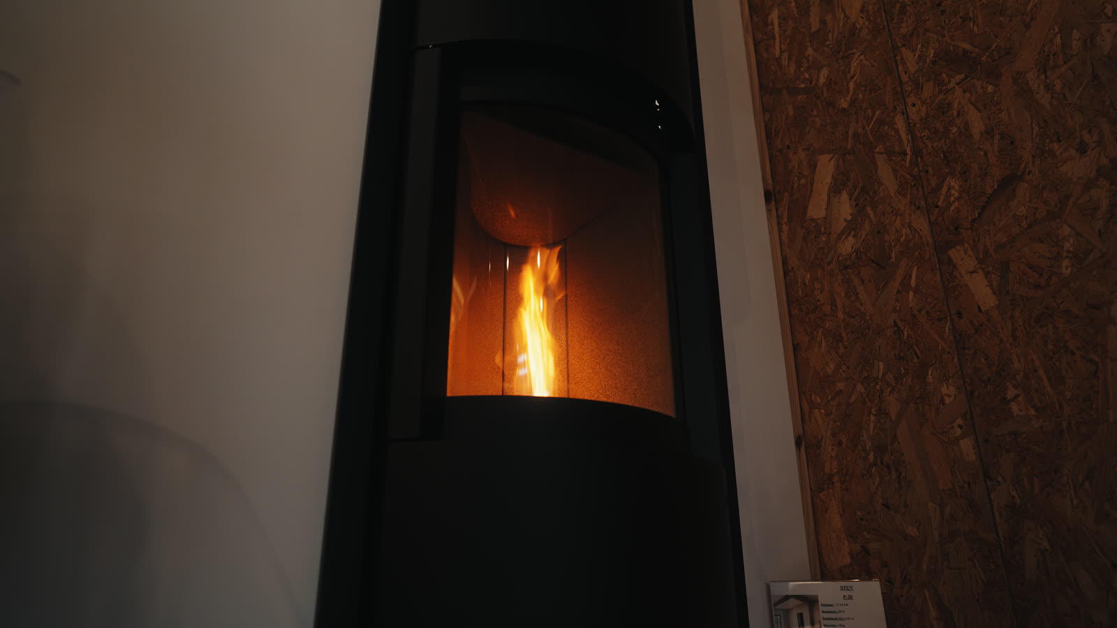 Un poêle allumé, la flamme derrière la vitre