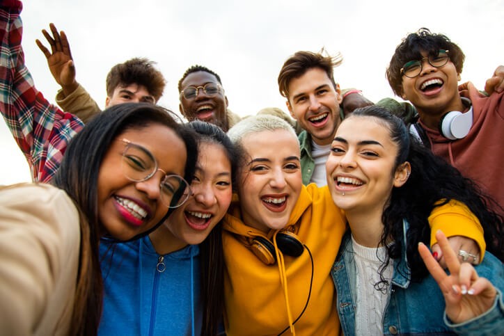 A group of smiling multiracial students at our private school