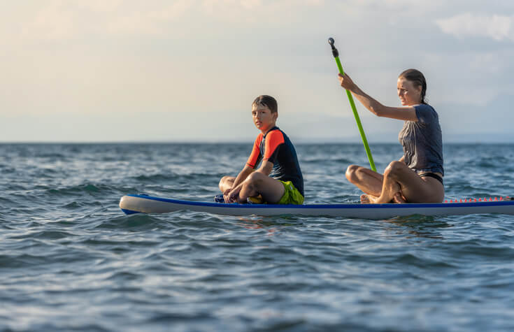 two private school students windsurfing together
