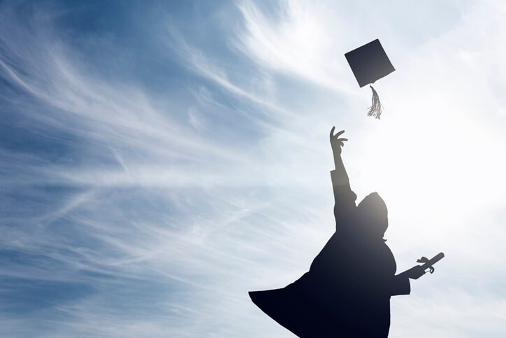 A Swiss boarding school student throwing a cap at graduation