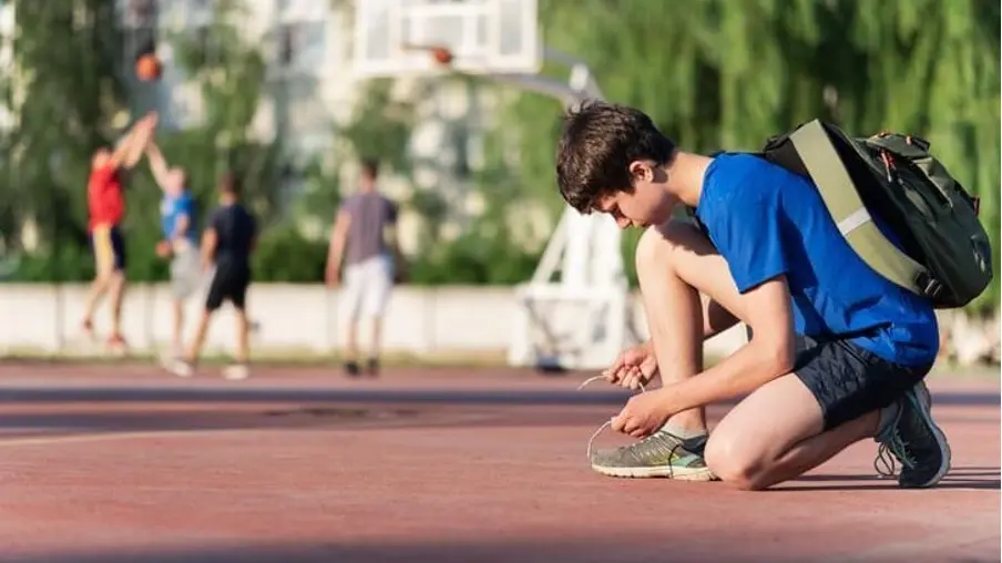 A student preparing for a team sports athletic challenge on campus