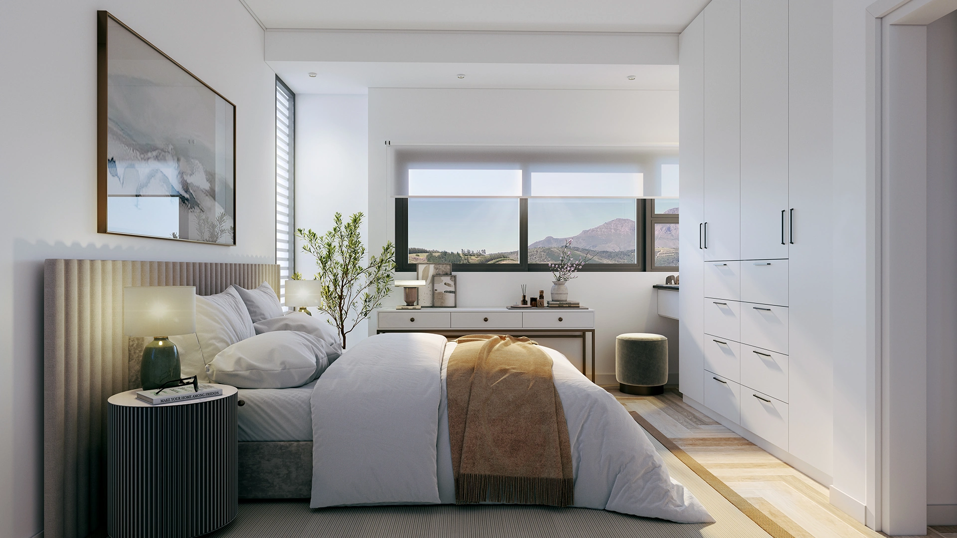Modern bedroom with a large bed, white bedding and brown throw, nightstand with lamp, large window with mountain view, and white built-in wardrobe.