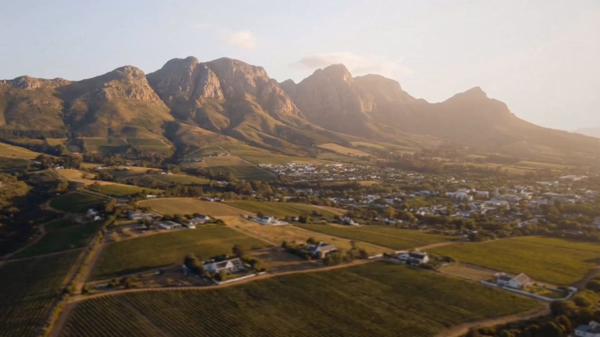 Golden-hour view over the Stellenbosch winelands and mountains near Oakhills Estate