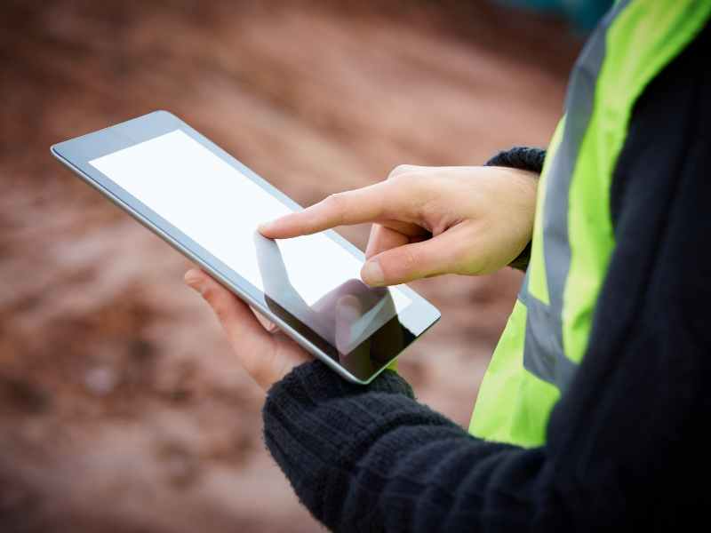 Facilities leader completing self-storage vendor compliance self-check on tablet