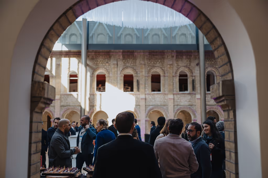People gathered and chatting in a courtyard during a social event.