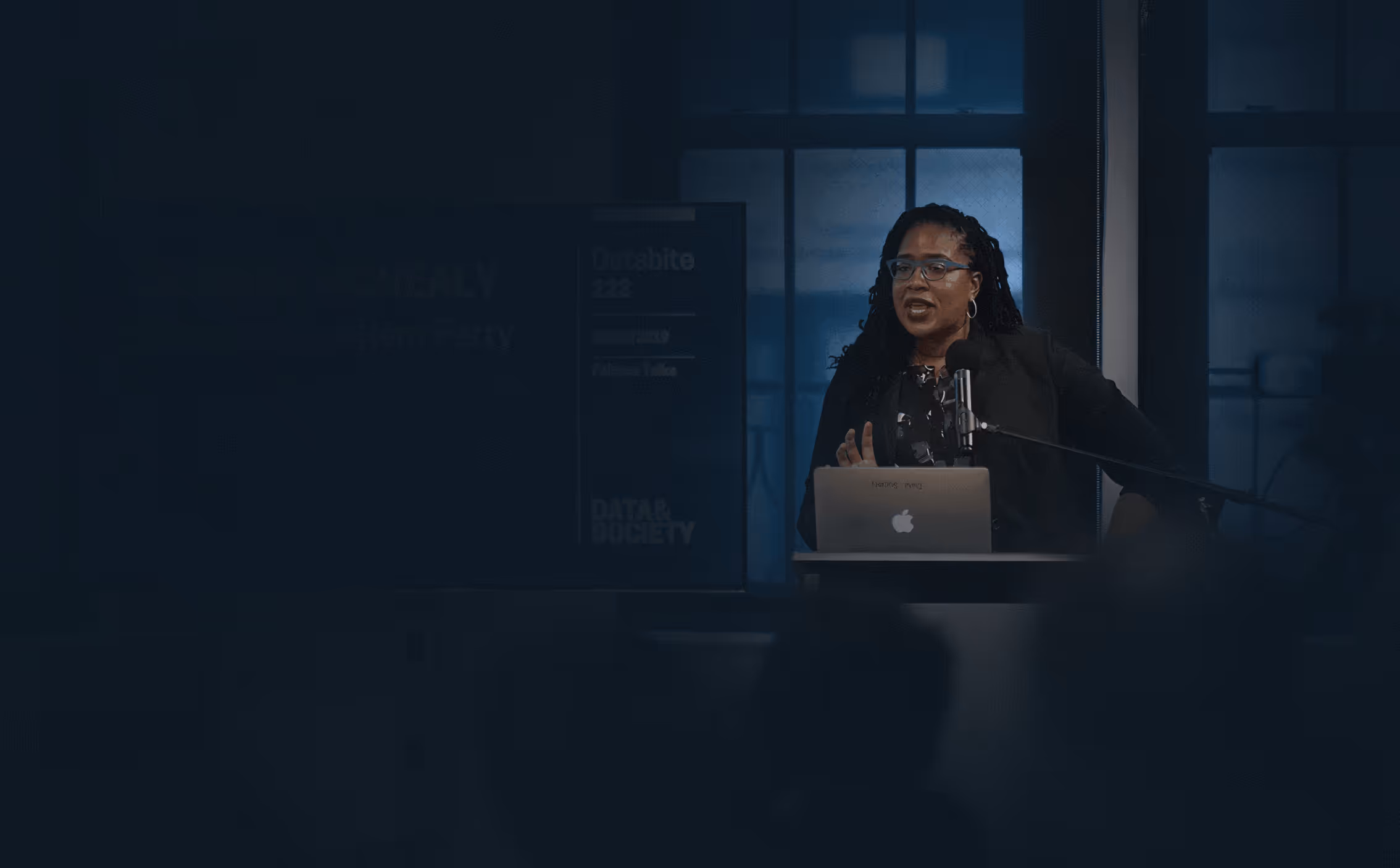 Jasmine McNealy speaking at a podium during a technology policy presentation.