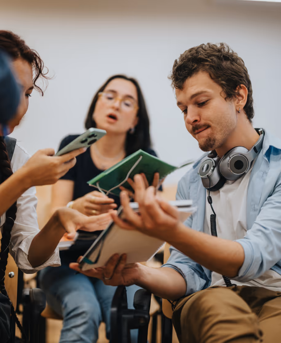 Small group reviewing notes and phones during a public interest technology discussion.