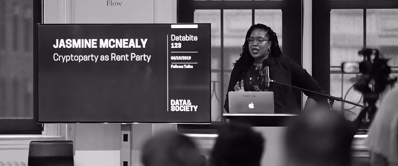 Jasmine McNealy speaking at a Databite event beside a slide reading Cryptoparty as Rent Party focused on technology policy.