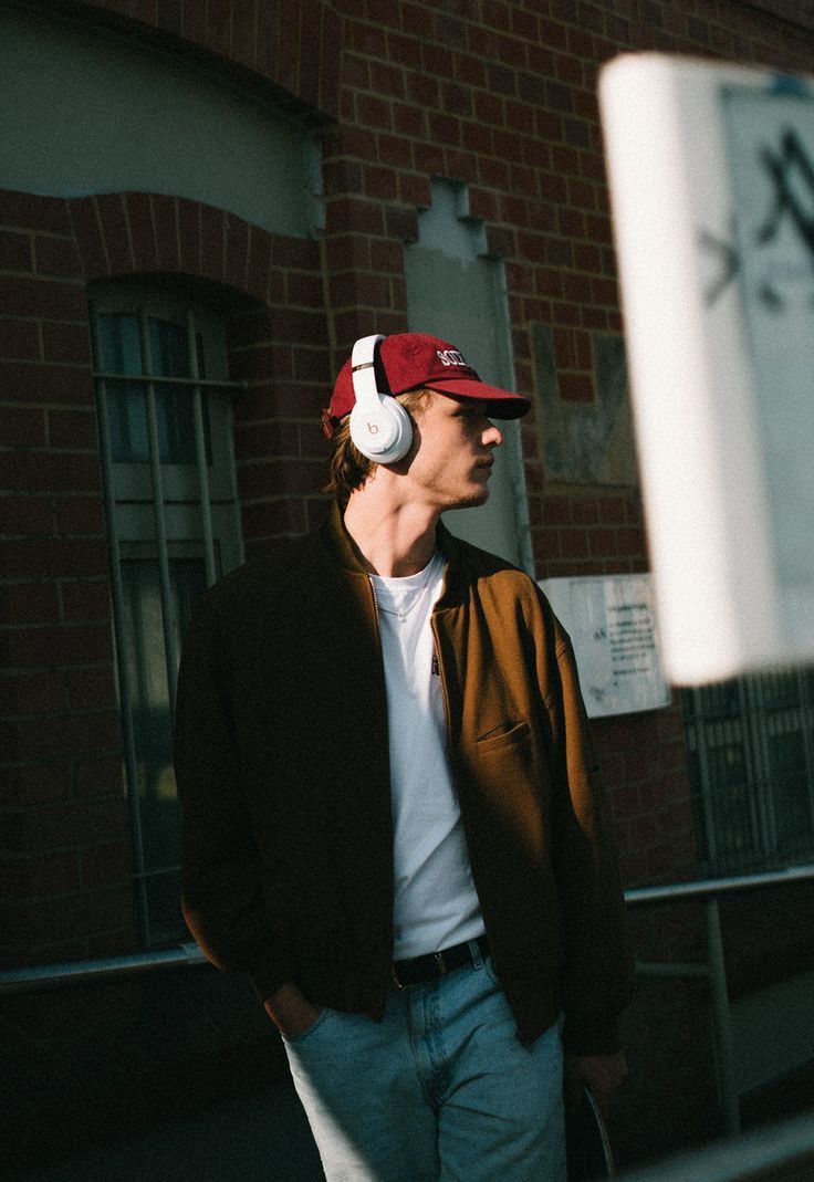 Young man listening to music with headphones on the street.