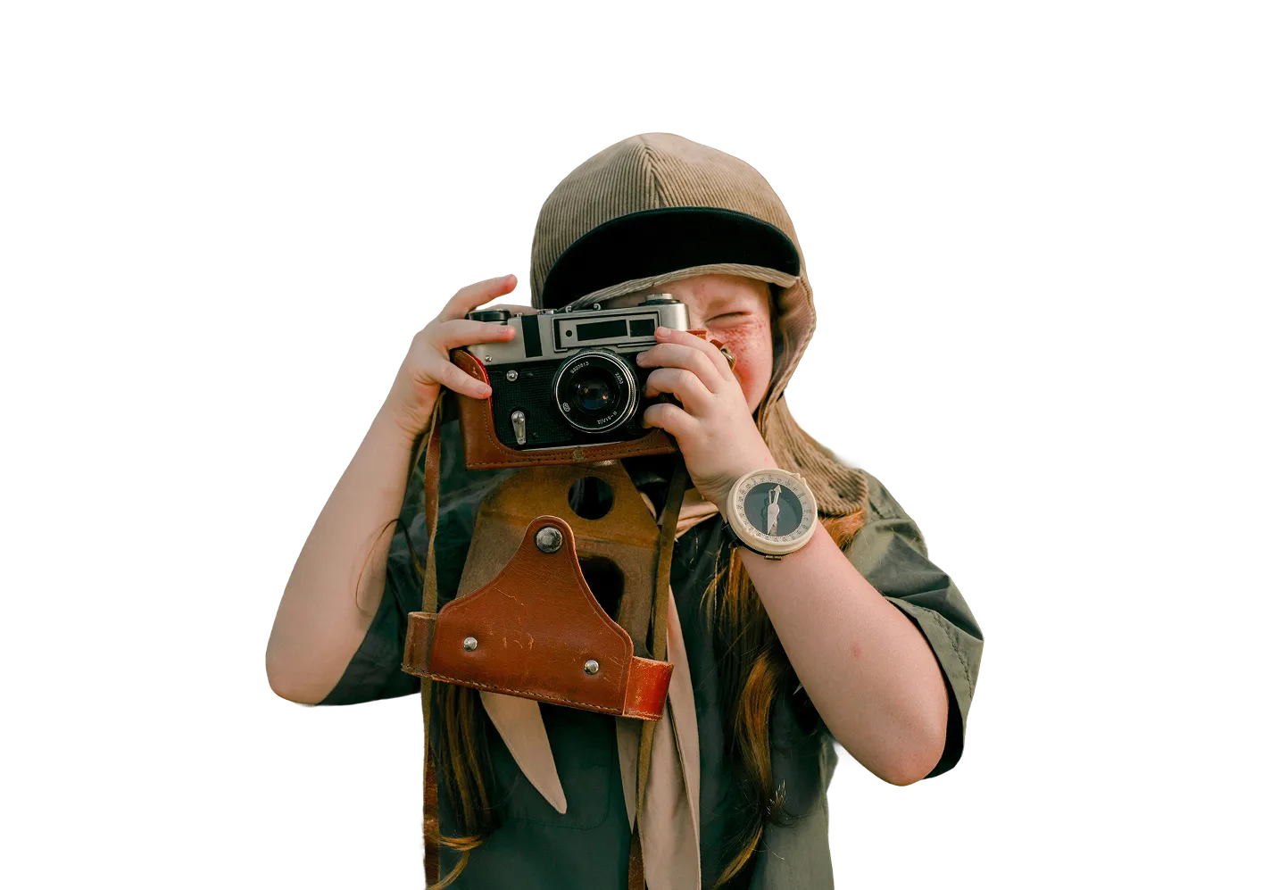 Child wearing a cap and scout uniform, holding a vintage camera close to their face, preparing to take a photo.