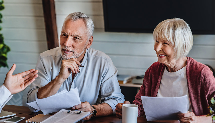 Retired couple going over finances with a financial advisor