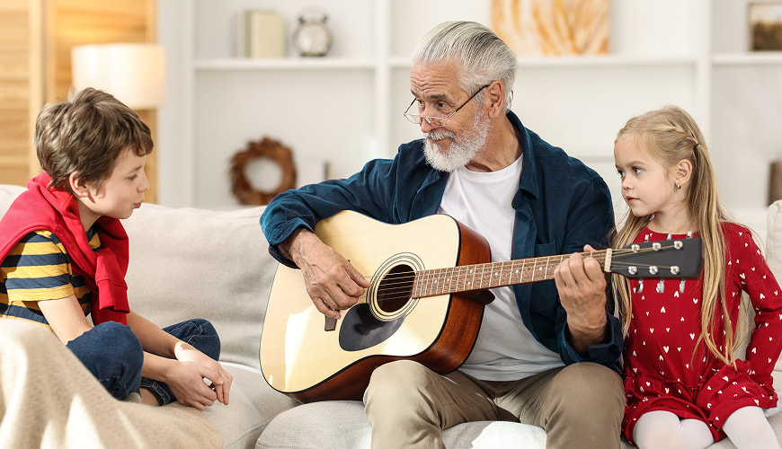 Retiree playing guitar to his grandchildren