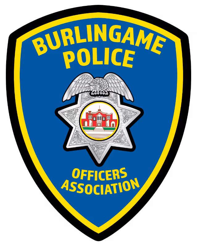 Burlingame Police Officers Association badge with an eagle atop a star and a red building emblem in the center.