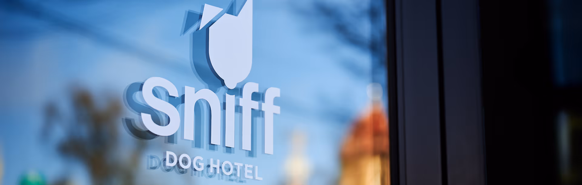Sniff Dog Hotel logo on their front window.