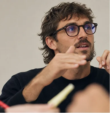 A researcher mid-sentence during a discussion