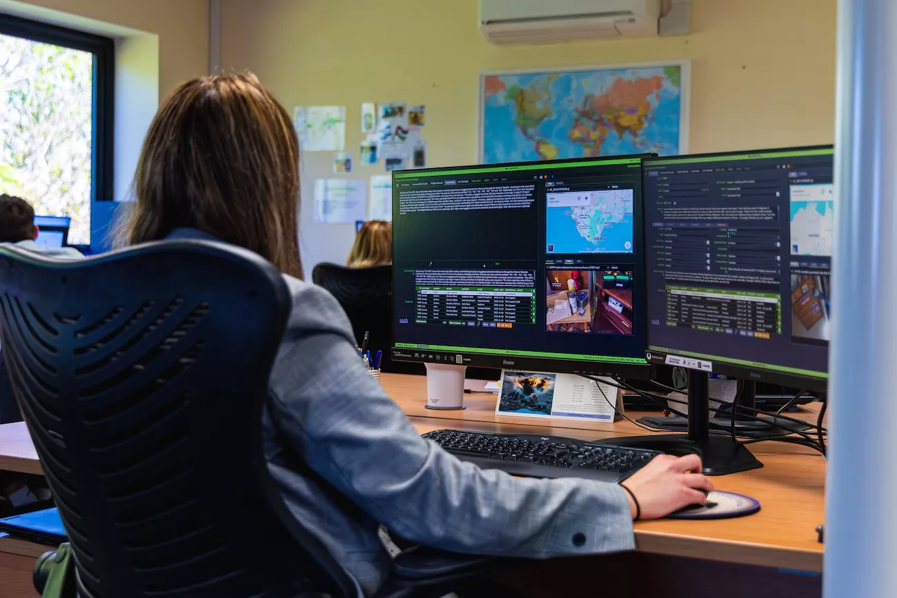 EWS intelligence analyst monitoring global IED and RCIED threat data on the Open Source Threat Database (OSTD)