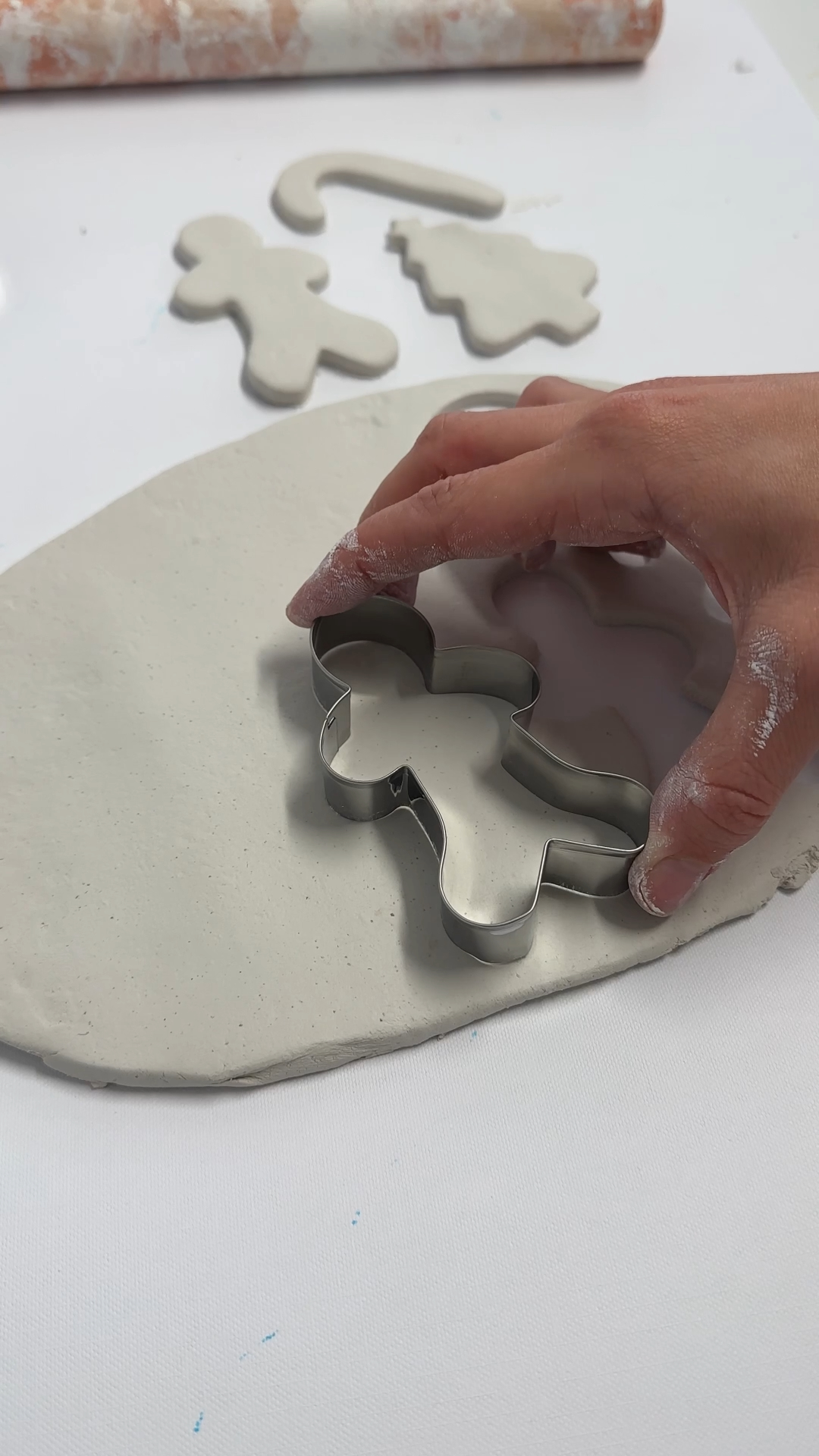 ginger bread cutter pressed into flattened clay slab.