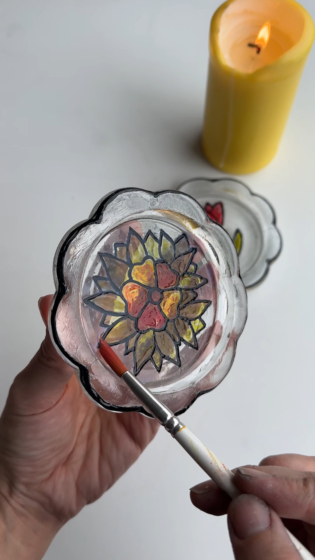 applying gloss sealer to protect painted stained glass flower coaster