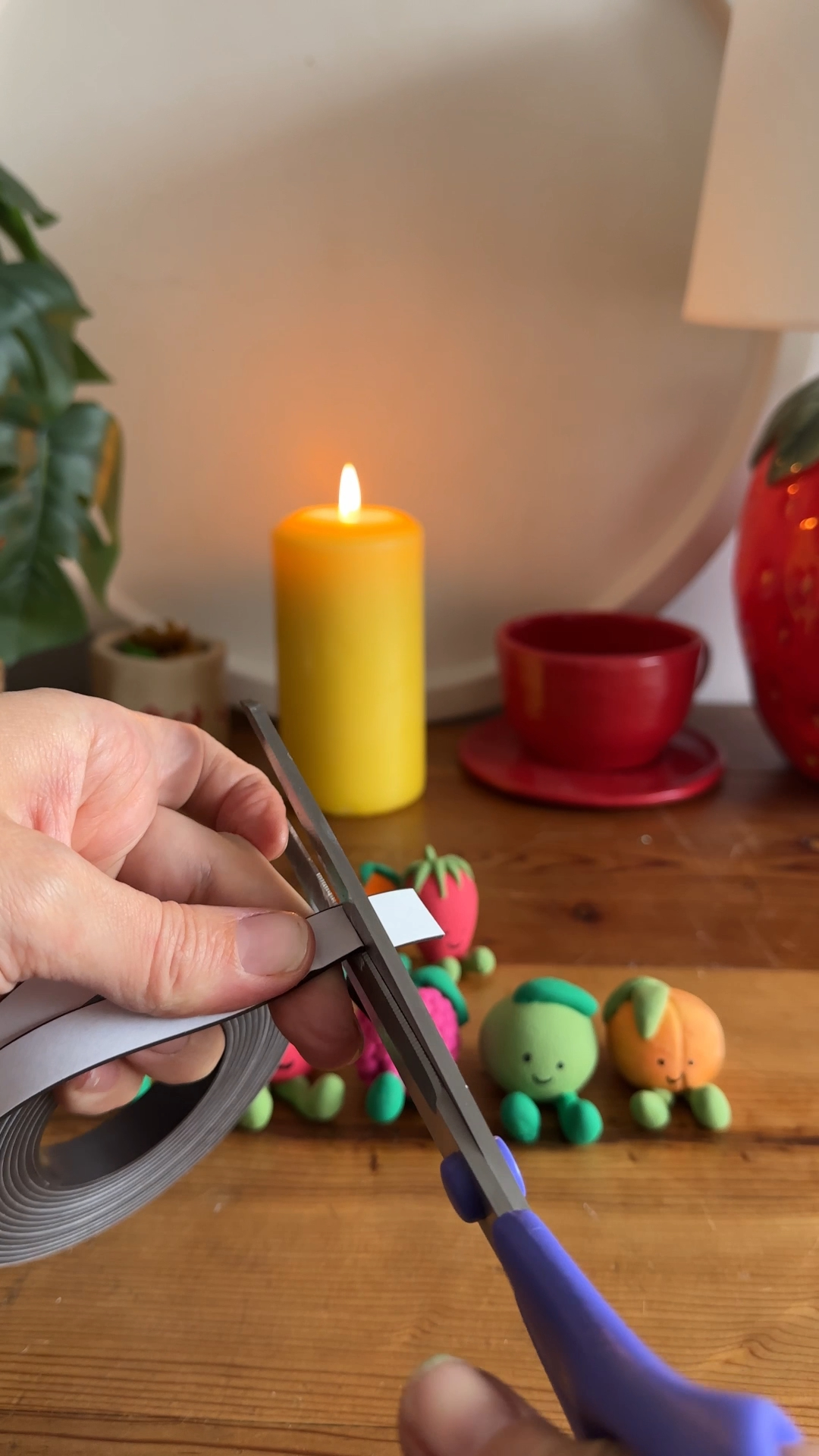scissors cutting small pieces of magnet strip