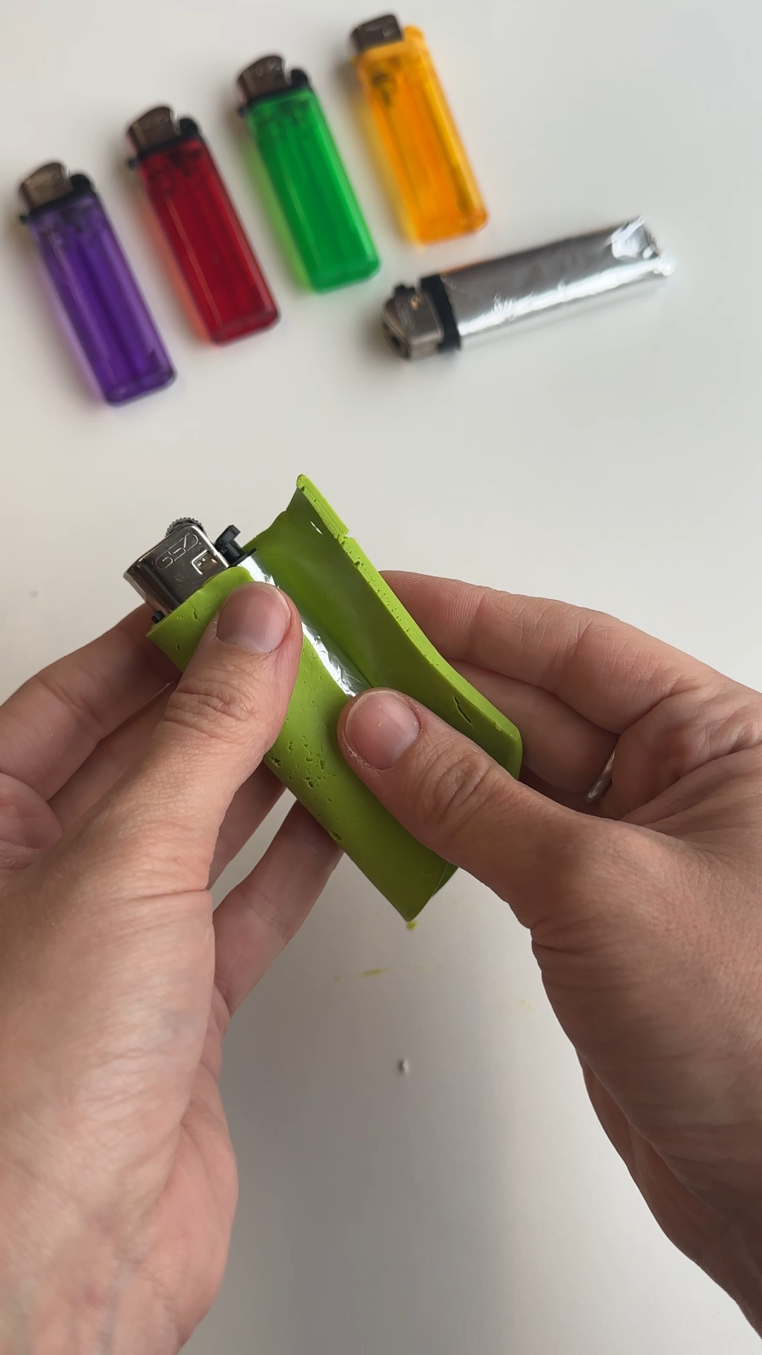 smoothing polymer clay around lighter and blending seam evenly