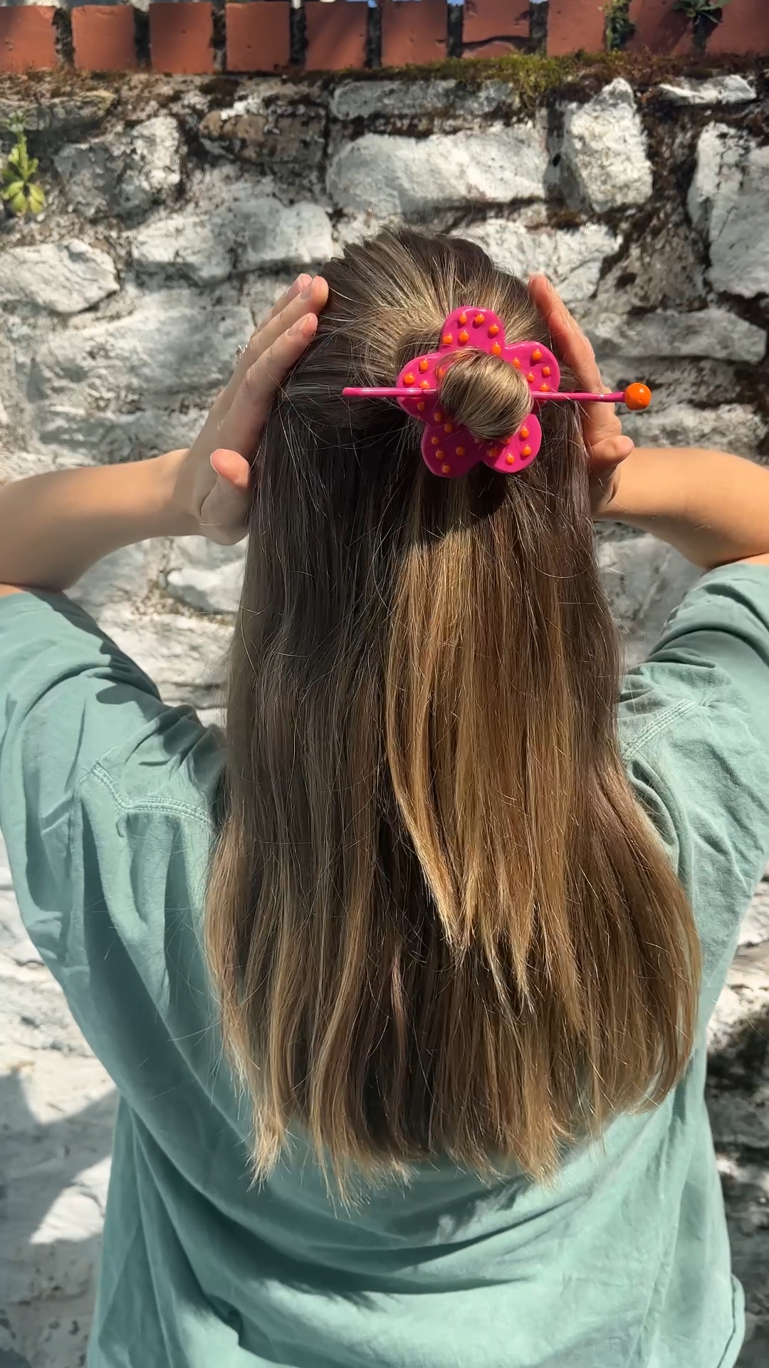 finished diy polymer clay hair pins in strawberry and flower shapes being modelled by a girl with long blonde hair