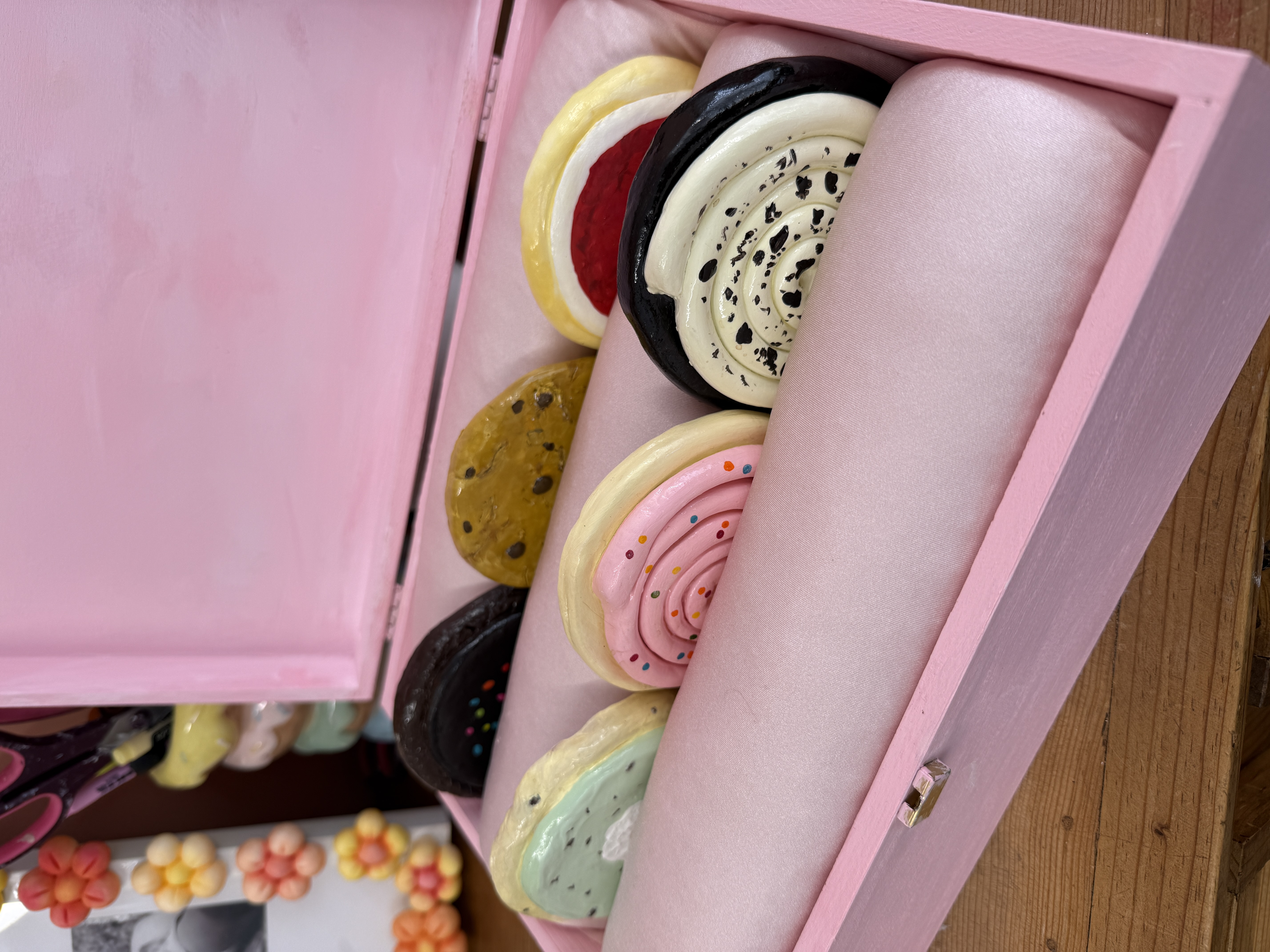 finished diy crumbl-inspired cookie coasters gift box with six clay cookies inside a pink cushioned interior