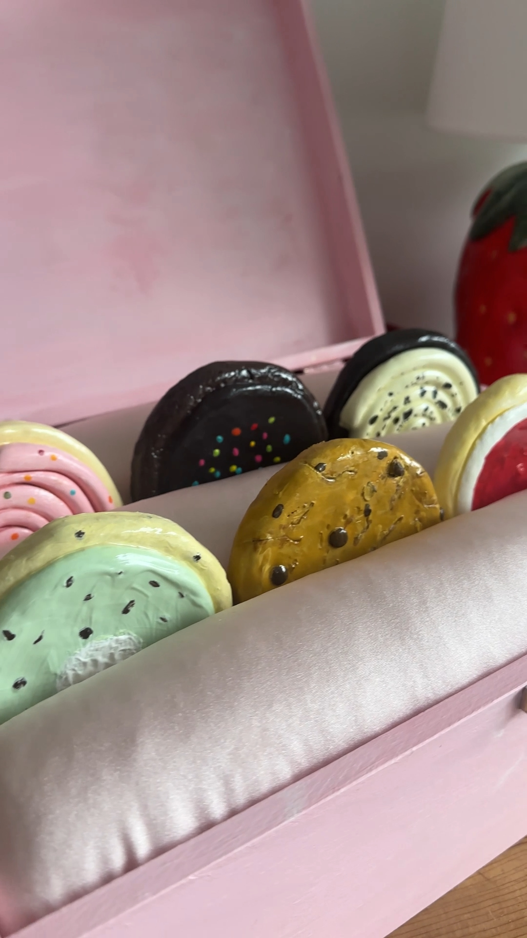 pink confetti cookie coaster placed inside the cushioned gift box