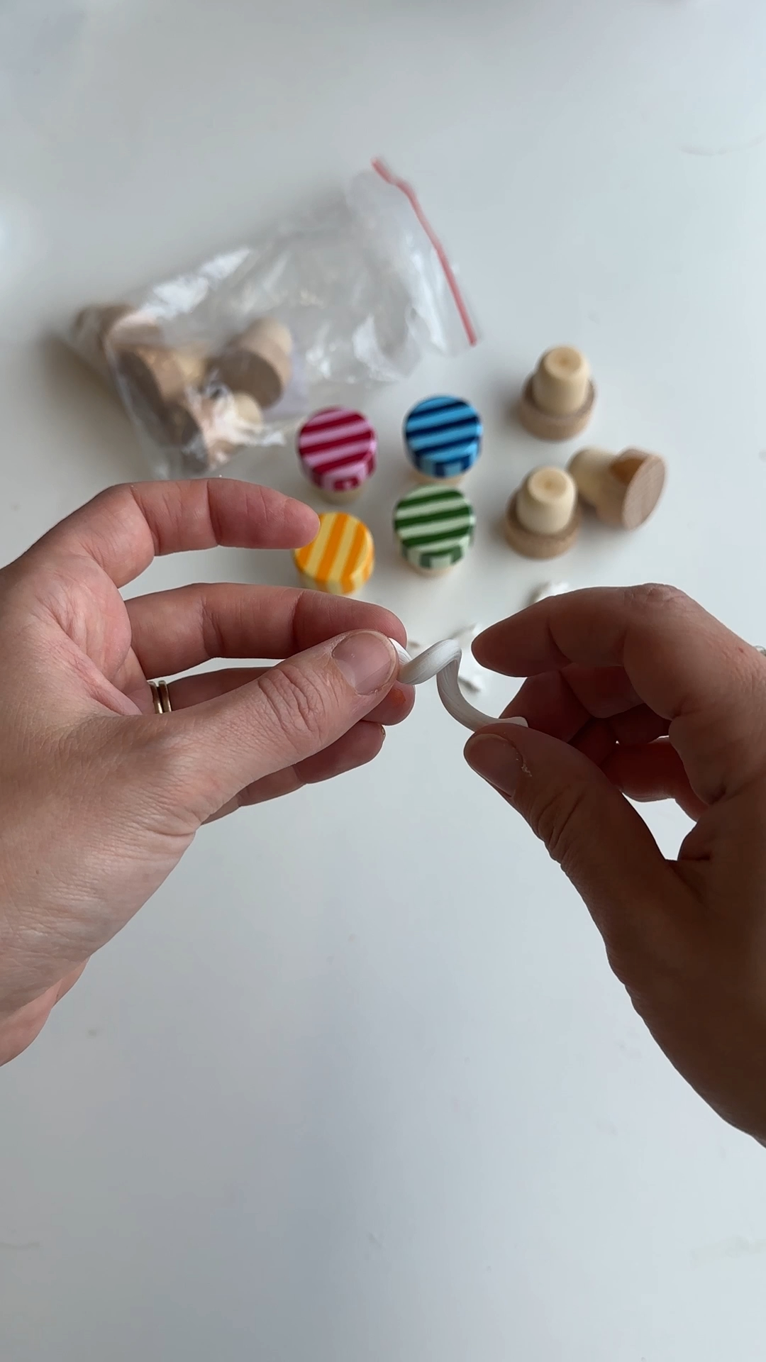 hands twisting a tapered polymer clay rope to make a fusilli spiral