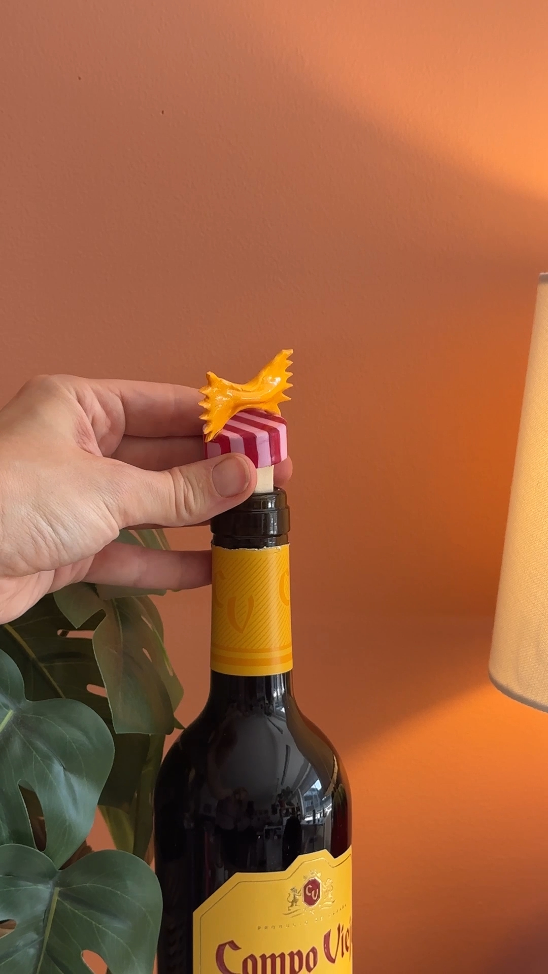 finished pasta wine stopper being tested in the opening of an empty wine bottle