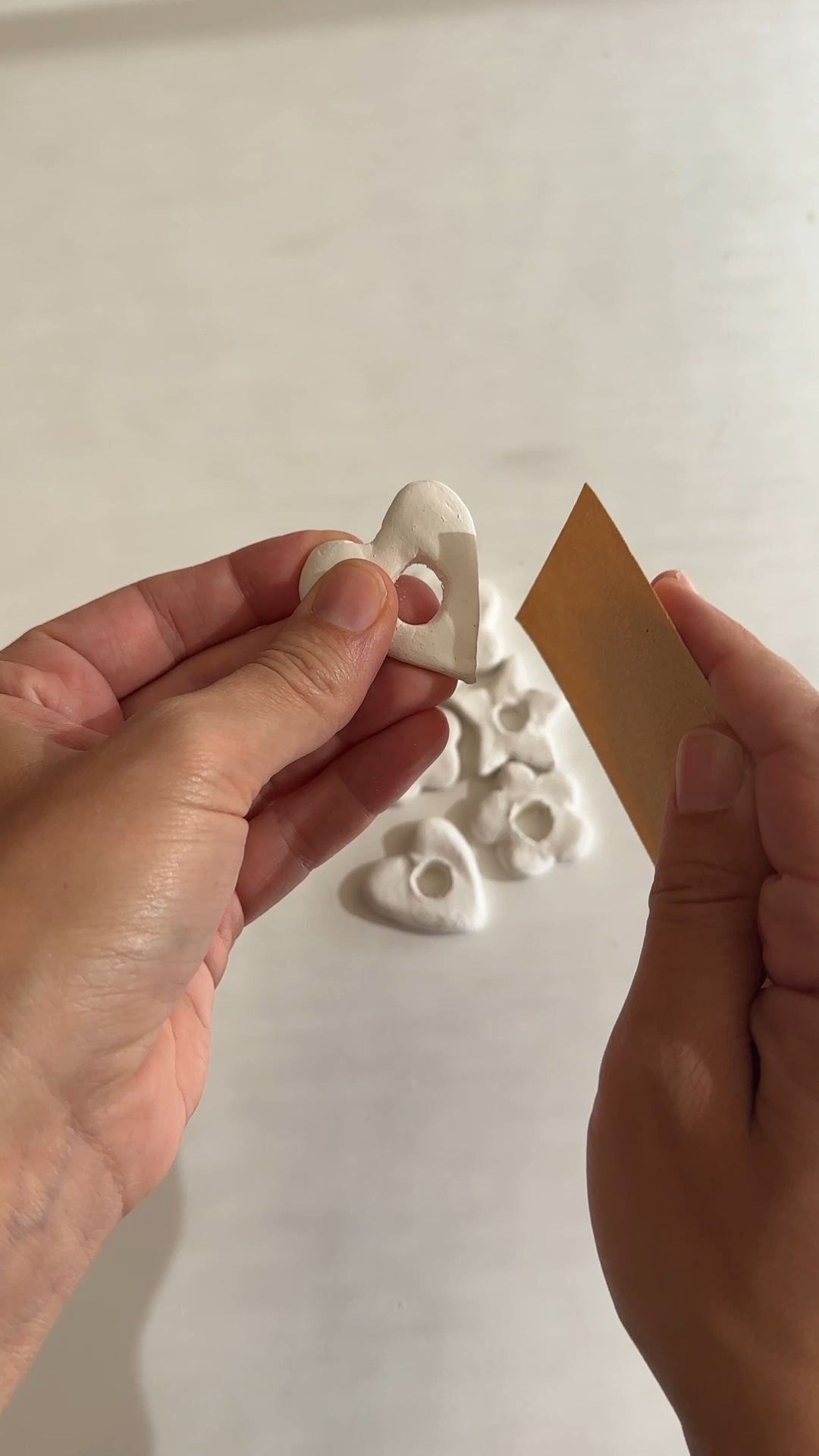 dry air dry clay sunglasses holder being sanded around its edges and central opening